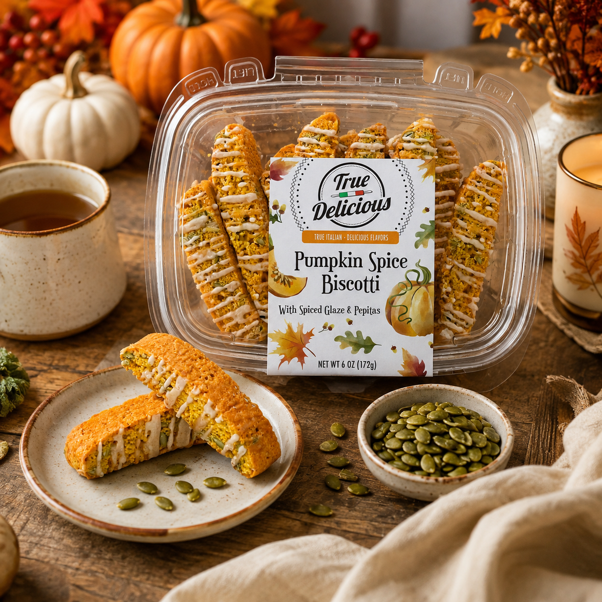 A jar of True Delicious Pumpkin Spice Biscotti with Glaze & Pepitas sits atop a wooden table, accompanied by tea, a bowl of pepitas, a biscotti-filled plate, and autumn decor such as pumpkins and colorful leaves. Each piece is made from natural ingredients to highlight the comforting flavors of fall.